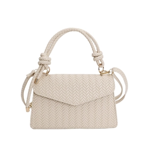 Cream woven texture crossbody flap bag with top handle and elegant gold-tone hardware