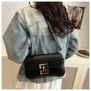 Minimalist black faux leather crossbody bag featuring a classic gold-tone metal lock buckle