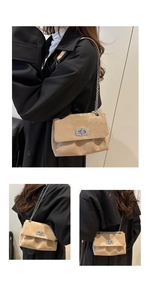 Close-up of beige suede chain bag featuring a silver rhinestone-studded rectangular lock