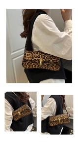 Detail of leopard print baguette bag featuring horsehair texture and gold metal buckle