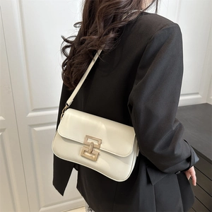 Chic ivory rectangle shoulder bag with gold interlock buckle worn by a model