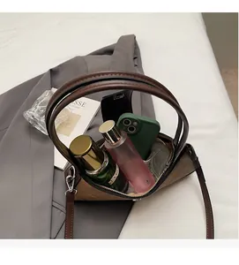 Detailed interior of the brown baguette bag showing large capacity for phone and cosmetics