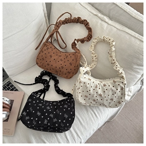 Corduroy shoulder bags with ribbon bow prints and ruched straps shown in three colors