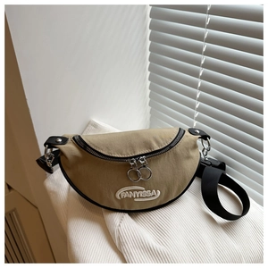 Détail du sac de poitrine croissant kaki avec broderie blanche et fermetures éclair