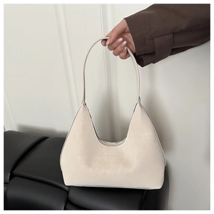 Detail of cream white hobo bag with embossed lettering and matte crescent texture
