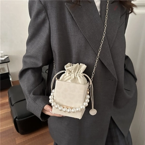 Elegante borsa a secchiello bianco crema con grande manico di perle e catena d'oro