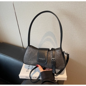 Close-up of the canvas and leather mix underarm bag with a focus on its adjustable strap