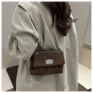 Brown suede square shoulder bag with silver chain and artistic twist lock closure