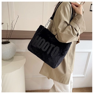 Close-up of black faux fur tote bag with 3D HOOTO embroidery and chain shoulder strap