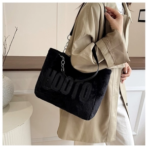 Detail of black plush tote bag with HOOTO letter embroidery and shoulder straps