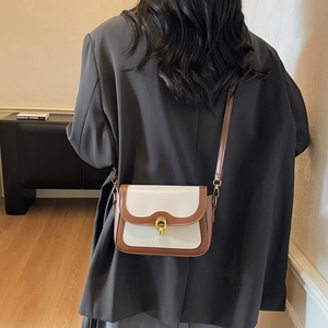 Vintage style bicolored leather crossbody square bag with golden round metal twist lock