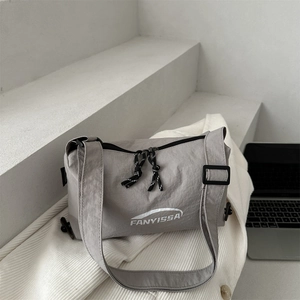 Gray nylon crossbody dumpling bag with adjustable wide strap for daily office commute