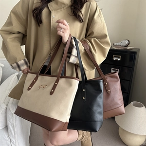Minimalist large-capacity tote bags in off-white, black, and brown with metallic bow details