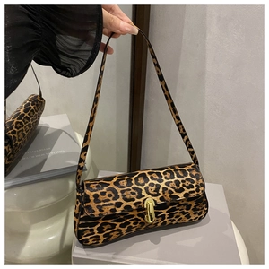 Detail of leopard print underarm bag featuring a gold U-shaped metal clasp and leather texture