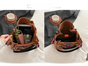 Brown tote bag interior showing large capacity for tablet, phone, and daily essentials