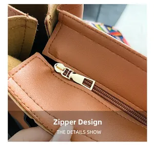 Detail of premium golden metal zipper and stitching on brown litchi leather handbag