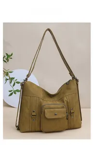 Detail view of mustard yellow canvas tote bag with metal rivets and front pocket
