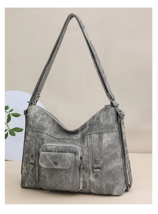 Detail of dark grey vintage tote bag showing retro washed texture and metal rivets