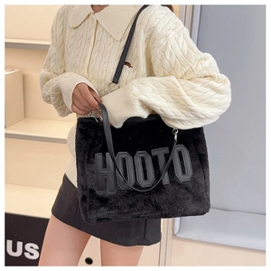 Detail of black faux fur tote bag showing the HOOTO letter patches and soft texture