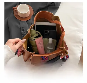 Detail view of brown tote bag with large capacity for tablet, phone, and daily essentials