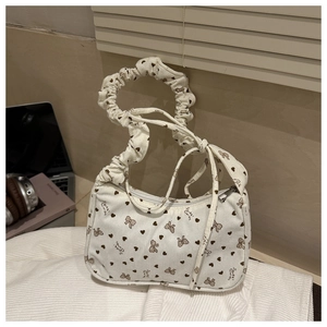 Detail of white corduroy mini bag with heart bow prints and ruched cloud handle