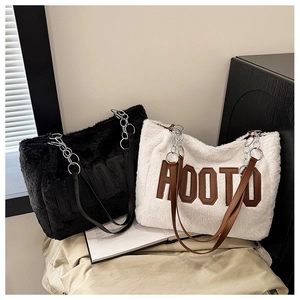 Close-up of plush faux fur tote bag with AOOTO letter patch and metal chain strap