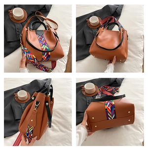 Detail view of brown PU leather tote with colorful woven strap and metal base rivets