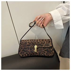 Close-up of leopard print underarm bag featuring an oval golden metal buckle and texture