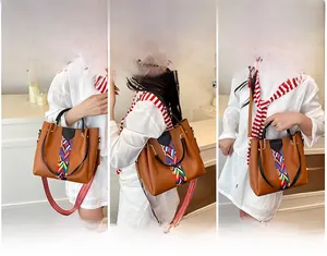 Three-way carry demonstration of brown faux leather bag with woven geometric strap