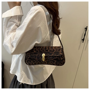 Detail of vintage leopard print baguette bag featuring a gold U-shaped metal buckle lock