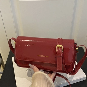 Deep red patent leather shoulder bag with gold logo and minimalist vintage design