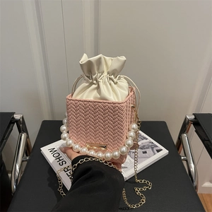 Pink hand-woven square handbag with faux pearl handle and gold chain strap
