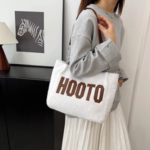 White fuzzy plush tote bag with brown HOOTO embroidery and chain leather strap