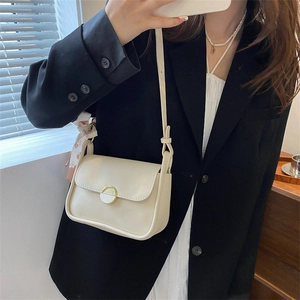 Minimalist beige crossbody bag with floral silk scarf detail and golden buckle