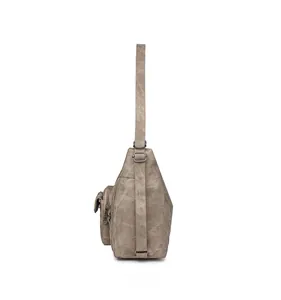 Side view of retro taupe crossbody bag with multiple zip pockets and adjustable strap