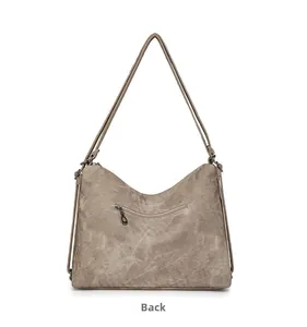 Detailed back view of a vintage faux suede hobo bag with a horizontal zipper pocket