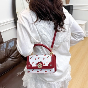 Fashionable red and white cherry print handbag with floral buckle and lace trim details