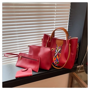 Macro shot of a four-piece burgundy handbag set with tote, pouch and card holder