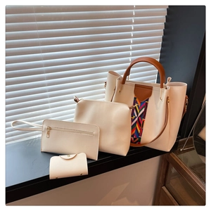 Detailed four-piece women's handbag set featuring off-white tote with ethnic woven straps