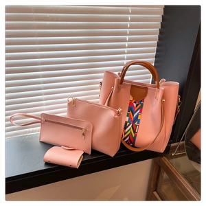 Pink four-piece handbag set featuring a tote and crossbody bag with colorful woven strap