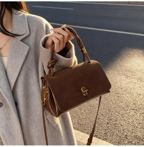 Brown suede messenger bag with knotted handle and vintage metal lock for women