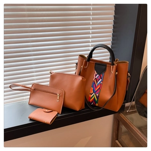 Detail of a 4-piece brown tote bag set with bohemian tribal pattern and gold hardware