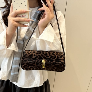 Leopard print baguette underarm bag with gold cylindrical metal lock and thin strap