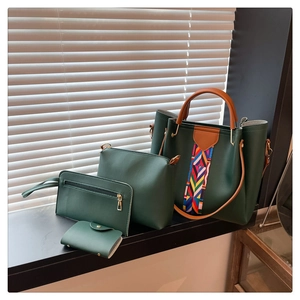Detail view of 4-piece dark green faux leather handbag set with tribal weave accents