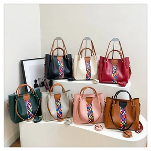 Litchi pattern leather tote bag set in seven colors with geometric strap detail