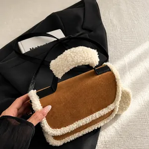 Detail of plush lamb wool trim and dark brown suede material on the stylish saddle bag