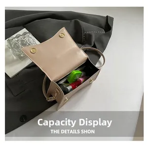Interior view of beige leather crossbody bag showing capacity for phone and lipstick