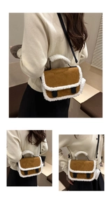 Close-up of brown suede crossbody bag with white faux shearling trim and black buckle straps