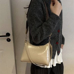 Minimalist cream shoulder bag for women with trapezoid design and patterned strap