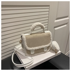 Detail view of beige suede crossbody bag with white sherpa trim and round coin purse